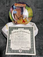 Front of plate on styrofoam base with Certificate of Authenticity visible