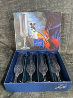 Retail presentation box showing Longchamp graphic and four flutes inside