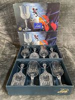 Eight crystal wine goblets in fitted box with Longchamp branding visible
