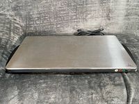 Top view of stainless GE warming tray with attached cord visible