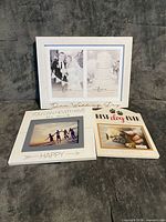 Front view of the three white Heart & Home picture frames showing printed text and photo openings
