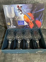Front view of boxed set showing four goblets and branded packaging