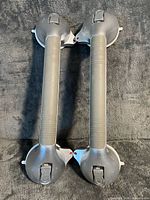 Front view of both grab bars showing handles, locking levers, overall condition