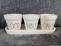 Front view of three planters on tray showing GOOD VIBES ONLY lettering