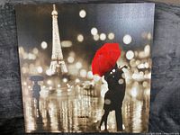Front view of canvas showing Eiffel Tower scene and red umbrella