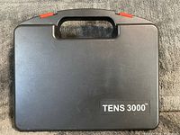 Closed black case showing TENS 3000 branding