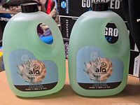 Front view of both sealed Alo hand soap refill jugs