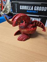 Side view of red Bakugan DEKA Dragonoid partially opened
