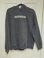 Front view of hoodie showing Iron Maiden logo and kangaroo pocket
