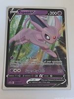 Front view of Espeon V promo card in protective sleeve