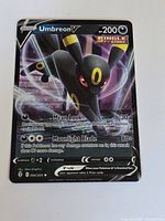Front of Umbreon V 094/203 card showing artwork, stats and holo surface
