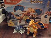 Box front and assembled Charizard with display base