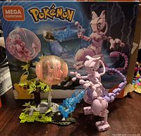 Box front showing Mega Construx Pokémon Mew vs Mewtwo set fully assembled