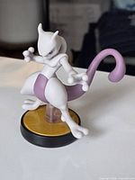 Front three-quarter view of Mewtwo amiibo on base