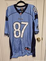 Front view showing light blue jersey, #87 and team colors