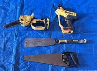 Group shot: DeWalt pruning chainsaw, pruning shears, pull saw, Stanley handsaw