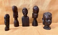 All five ebony busts lined up