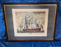 Full view of framed lithograph under glass