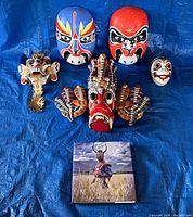 Front view of all five masks and book