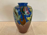Front view of signed Awaji ceramic vase showing blue upper body with multicolor drip glaze and brown lower section