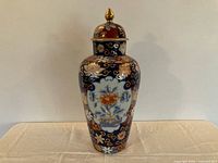 Full front view of lidded Imari vase showing overall shape and decoration