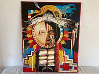 Full view of framed oil painting showing portrait and motifs