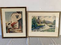 Both framed watercolour paintings side by side