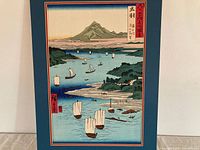 Frontal view of woodblock print mounted in blue mat