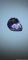 Pear-cut amethyst front view showing faceting and purple hue