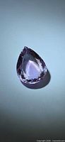 Front view of pear-cut amethyst showing color and facet pattern