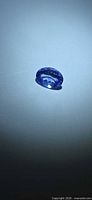 Front view of oval Tanzanite under spotlight