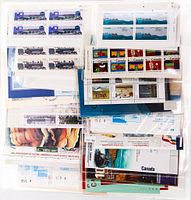 Stack of unopened Canadian stamp booklets and souvenir sheets in clear sleeves