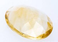 Oblique view of oval faceted yellow citrine quartz