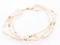 Full view of triple strand freshwater pearl bracelet showing gold spacers and clasp