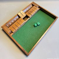 Overall view of walnut shut the box game with dice