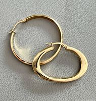 Both earrings front view showing shapes and gold color