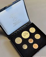 Open presentation case displaying seven 1974 specimen coins