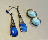 Both pairs of earrings front view showing design and stones