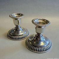 Front view of both Birks sterling candlesticks