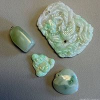 group shot of four jade pendants