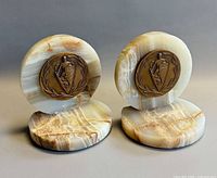 Front view of both onyx bookends showing bronze medals and stone striations