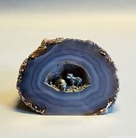 Front view of polished agate geode showing banding and interior bears