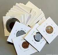 Stack and four sample coins in flips showing variety and count