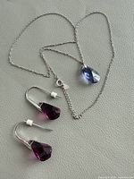 Necklace and earrings laid out showing overall design and metal marks