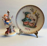 Plate and figurine front view, shows overall design, size relationship