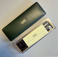 Closed green Cross case and clear plastic Cross sleeve