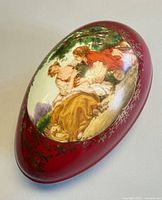 Top view showing painted pastoral scene and gilt scrollwork