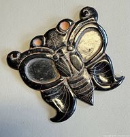 Front view of carved black jade butterfly ornament showing full design and characters