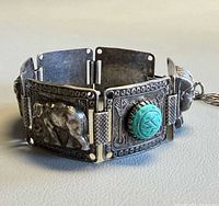 Front view showing relief elephant panel and turquoise cabochon