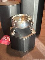 Overall view of sterling silver dish on display blocks